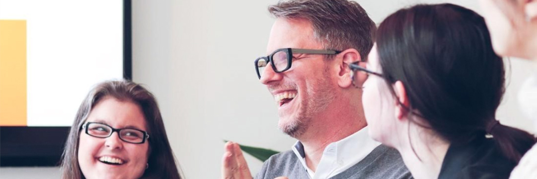 A photograph of Kirk and some coworkers laughing