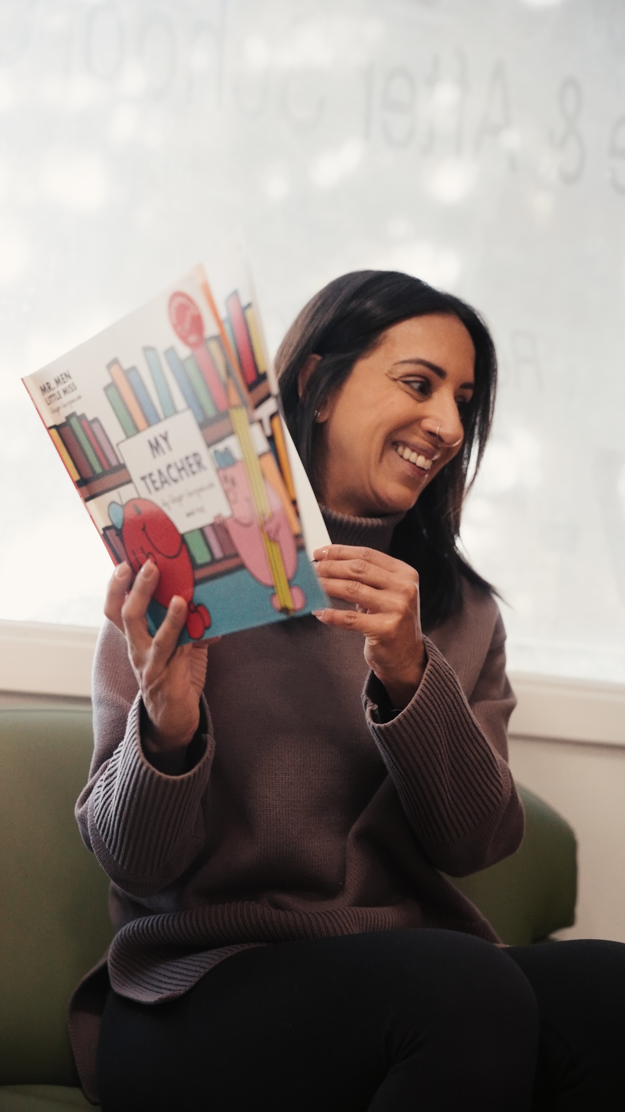 Selina reading to children at Tots 2 Kids