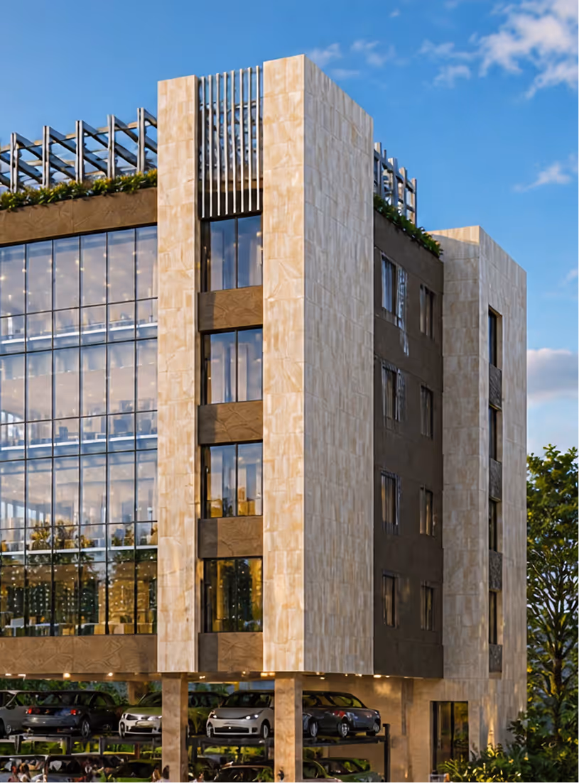Modern multi-story building with glass facade, beige stone exterior, rooftop greenery, and parked cars below.