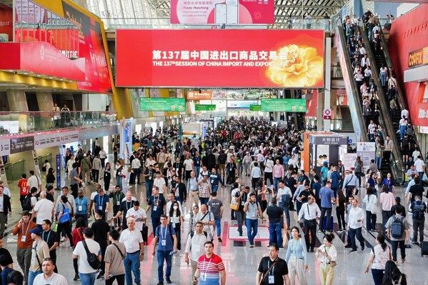 Crowd attending the 137th Session of China Import and Export Fair in a large convention center.