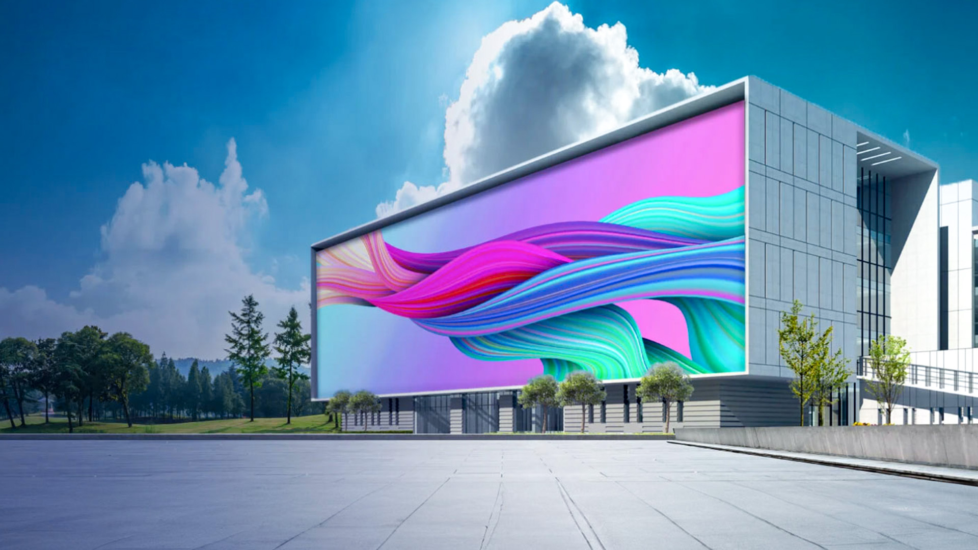 Modern building with a large colorful digital screen displaying abstract flowing lines outdoors.