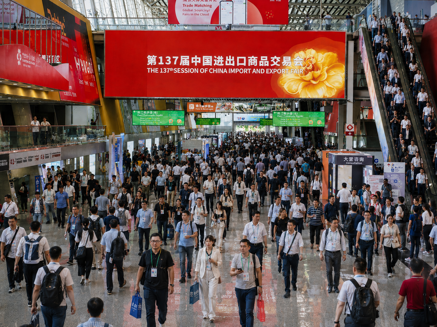 Crowd walking inside the 137th China Import and Export Fair exhibition hall with red event banners overhead.