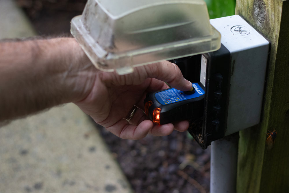 a pool inspector conducting a volt meter test with a volt meter