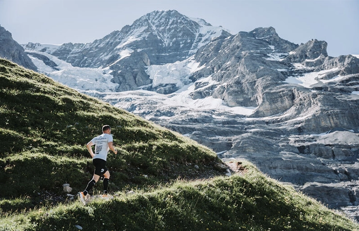 Trail runner in the mountains above Wengen