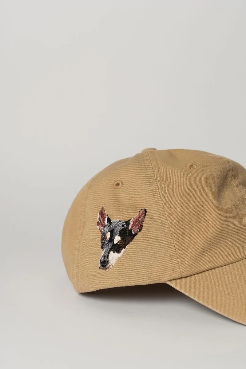 Tan baseball cap with an embroidered dog face on the side.