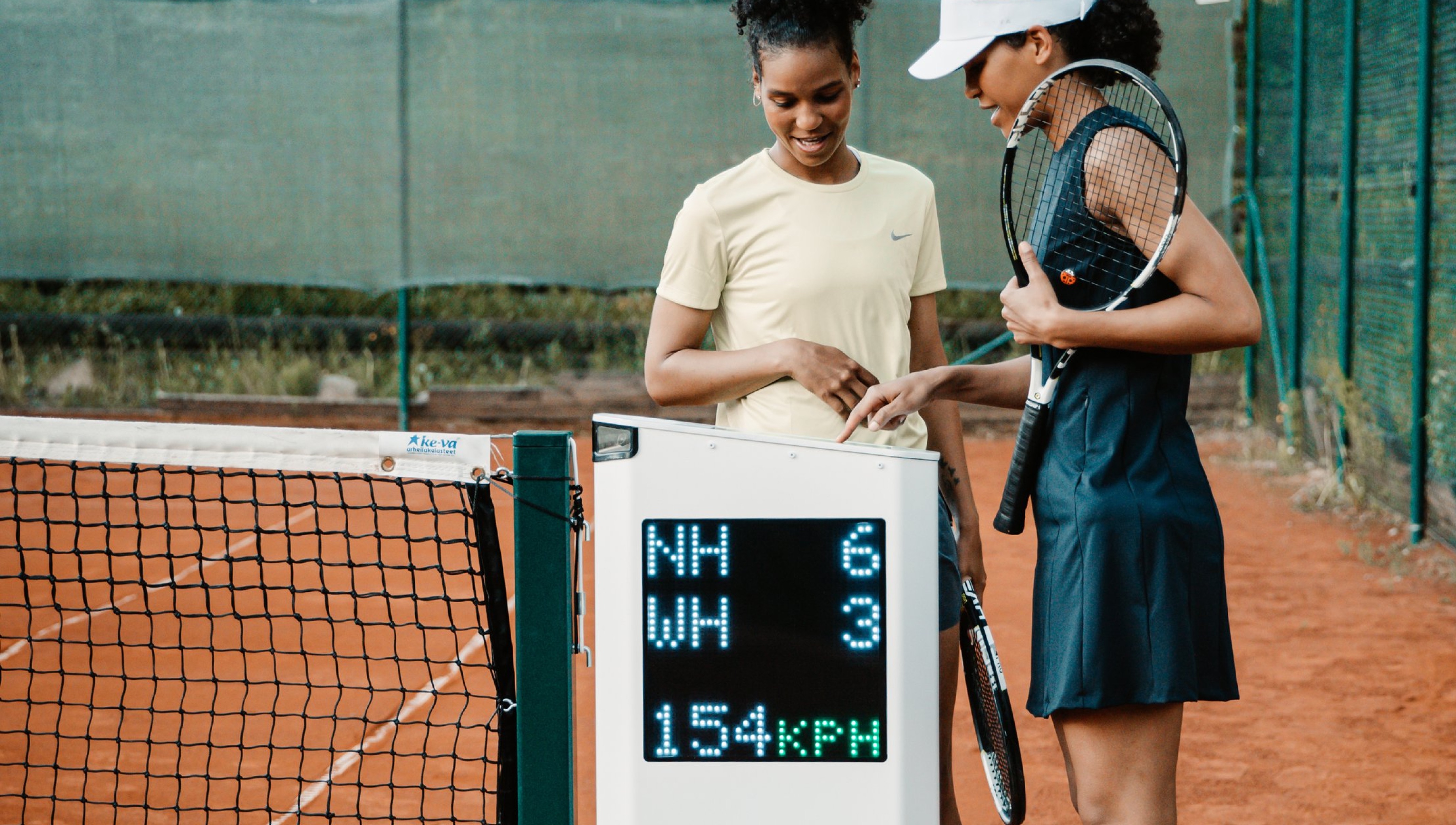 Tennis players reviewing their session on the Zenniz court device