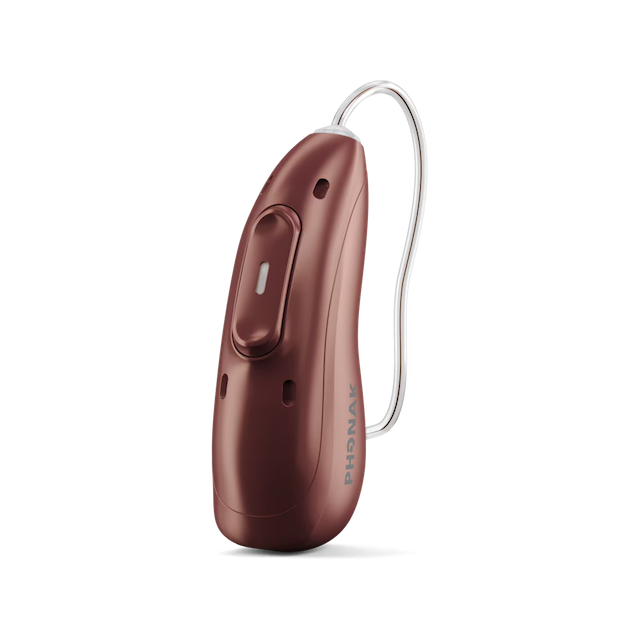 Close-up of a dark red Phonak hearing aid with an attached thin clear tube.