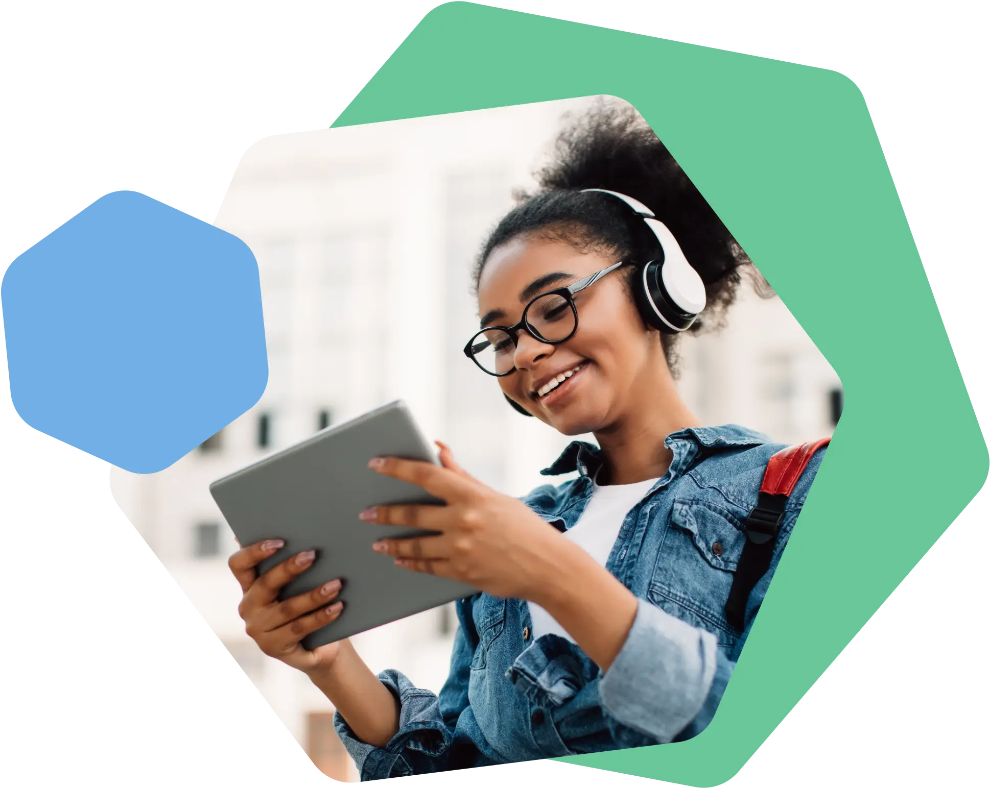 Young woman with glasses and headphones smiling while using a tablet outdoors.