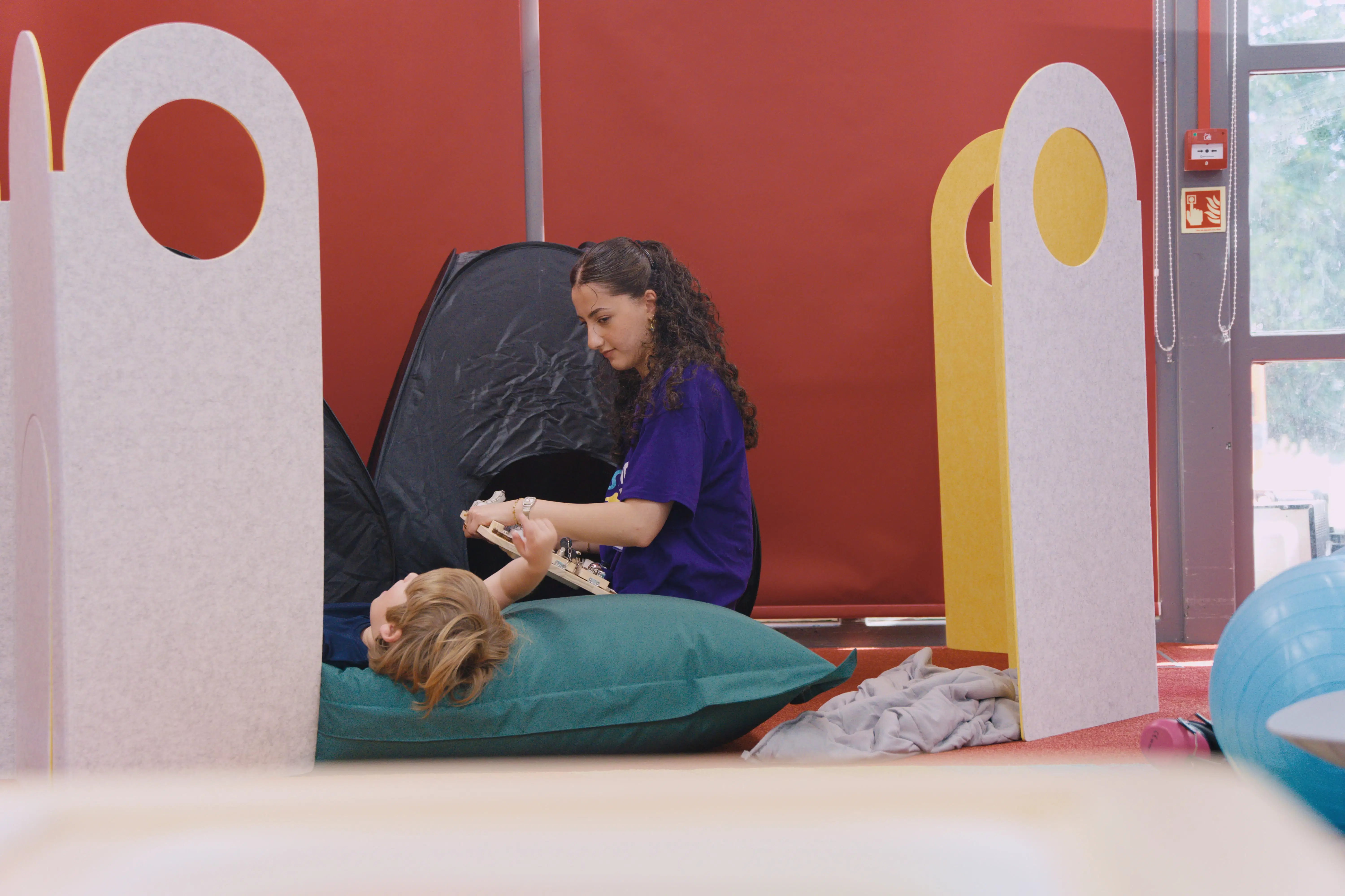 Child exploring sensory tools in a quiet corner