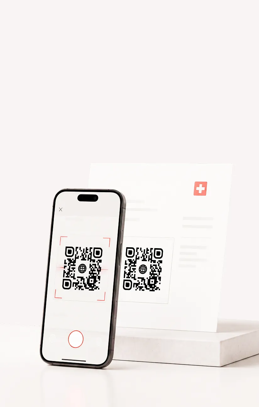 Smartphone scanning a QR code on a card placed on a white marble block.