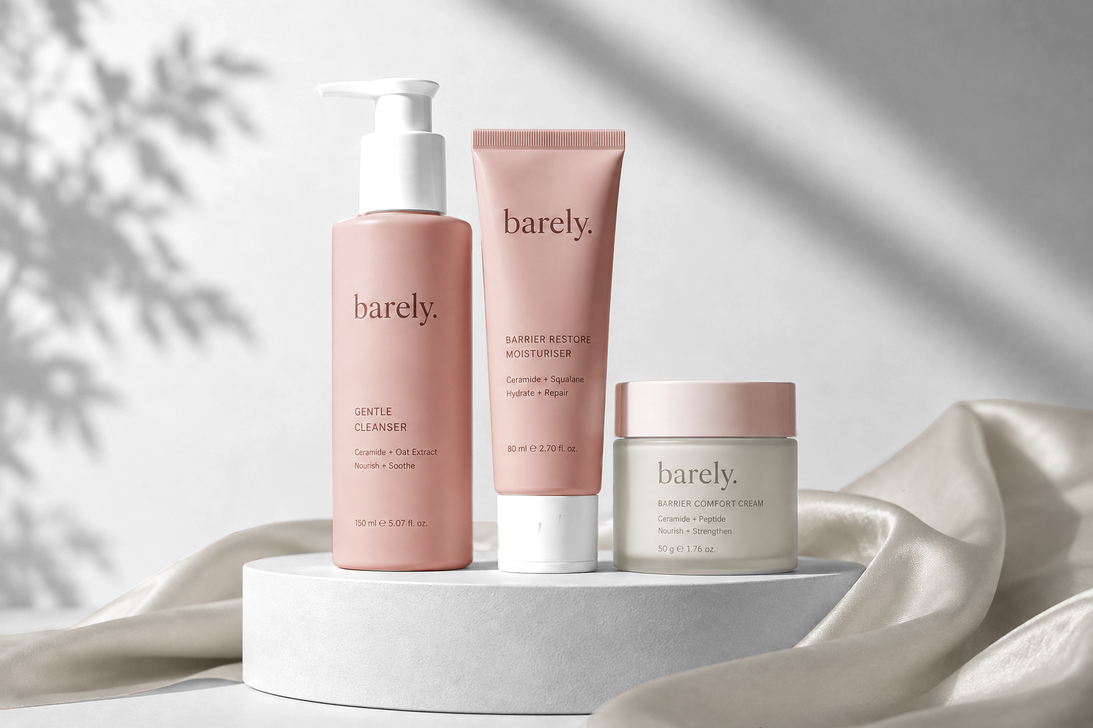 Barely skincare bottles and cream jar on a softly lit blush-pink surface