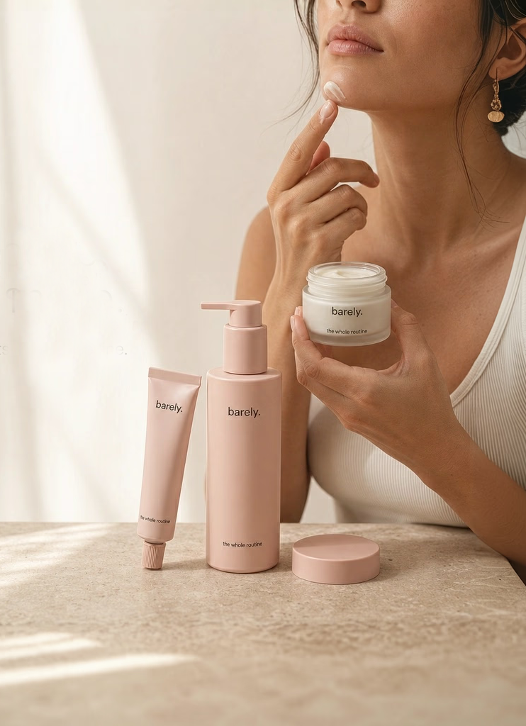 Three pink Barely skincare products displayed on a stone surface