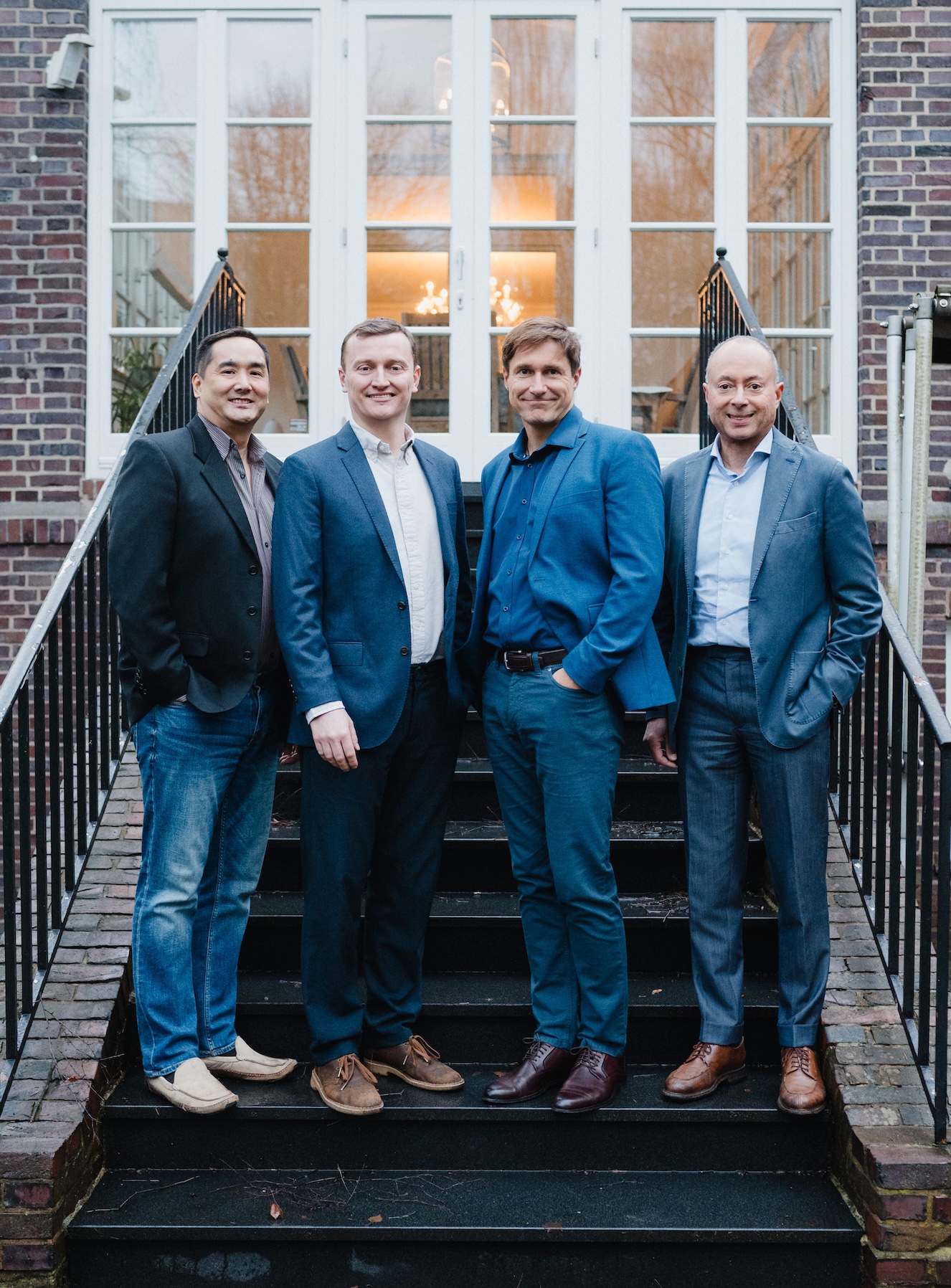 DeepCyte co-founders and team members in business attire standing on the steps in front of the company building