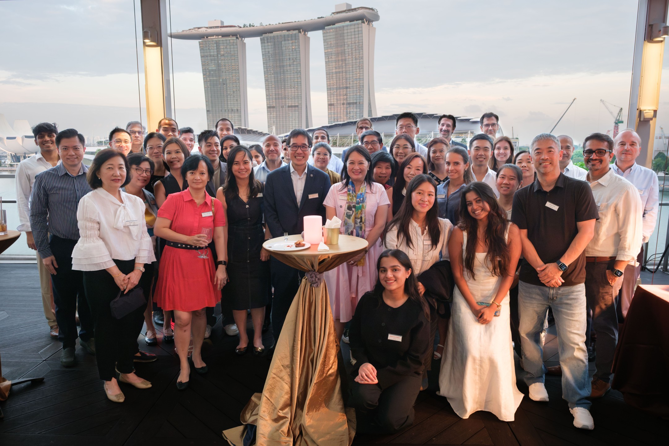 Guests gathered for a group photograph at sunset