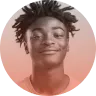 Portrait of a young person smiling with short dreadlocks against a peach and pink gradient background.