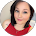 Portrait of a smiling woman with dark hair wearing red.