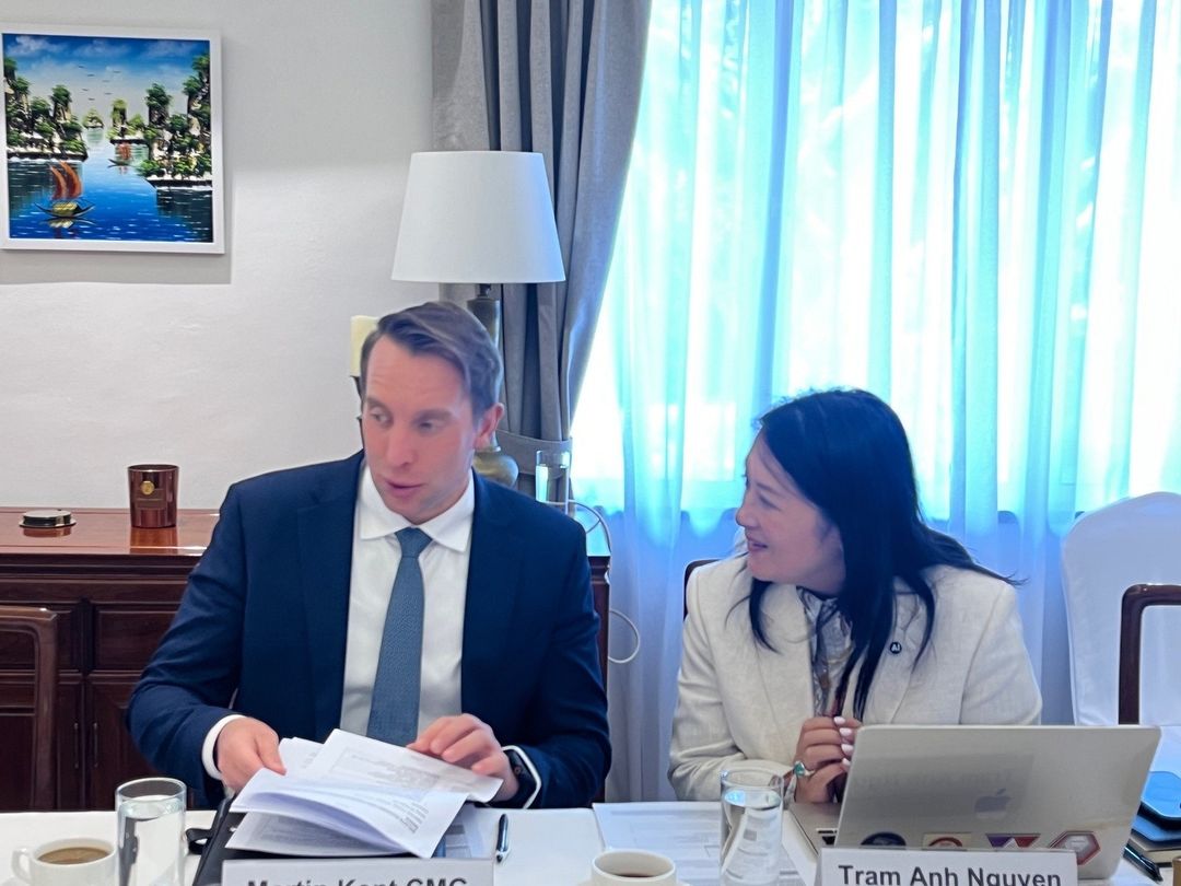 Martin Kent and Tram Anh Nguyen in discussion at the table