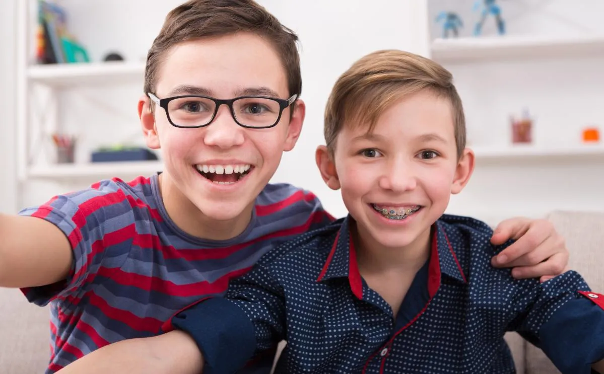 Two smiling teens with braces, from Friendly Neighborhood Orthodontist in La Grange, IL