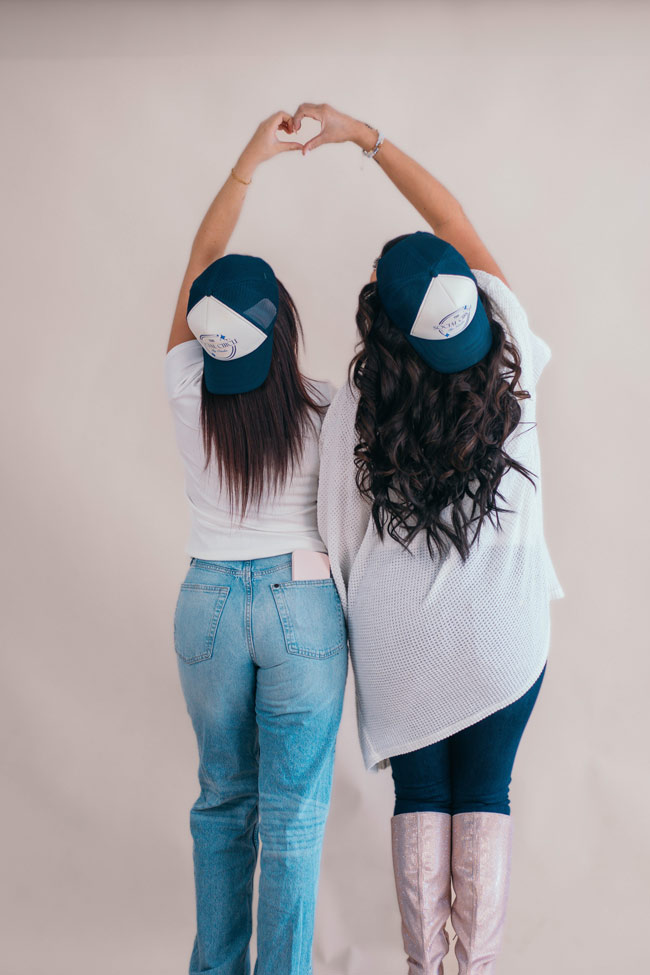 People forming heart shapes with their hands, representing connection and community