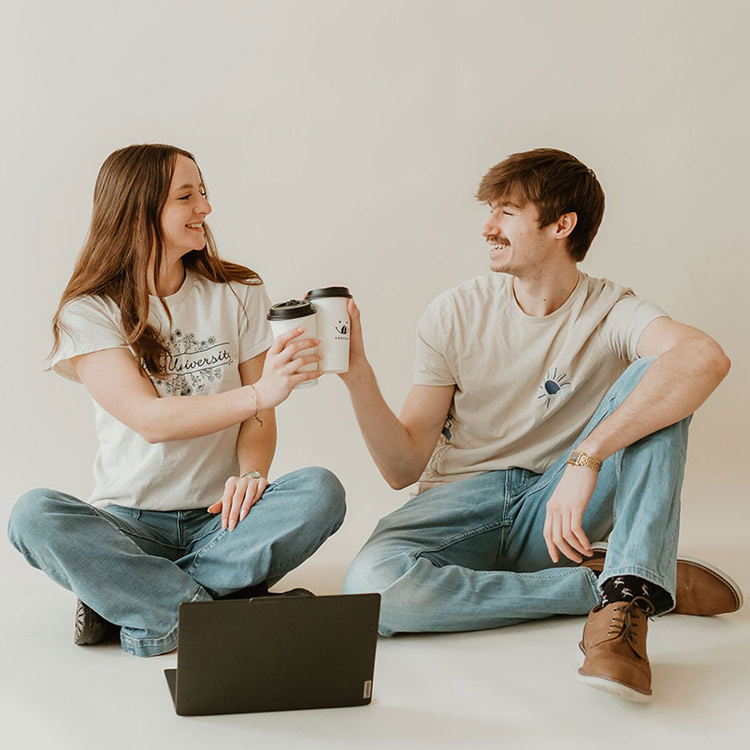Two team members from The Social Circle sharing coffee while working together in a creative studio space