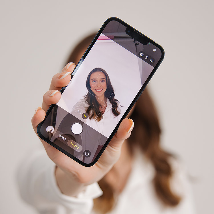 Smartphone displaying a selfie headshot being captured during a branding and content creation session
