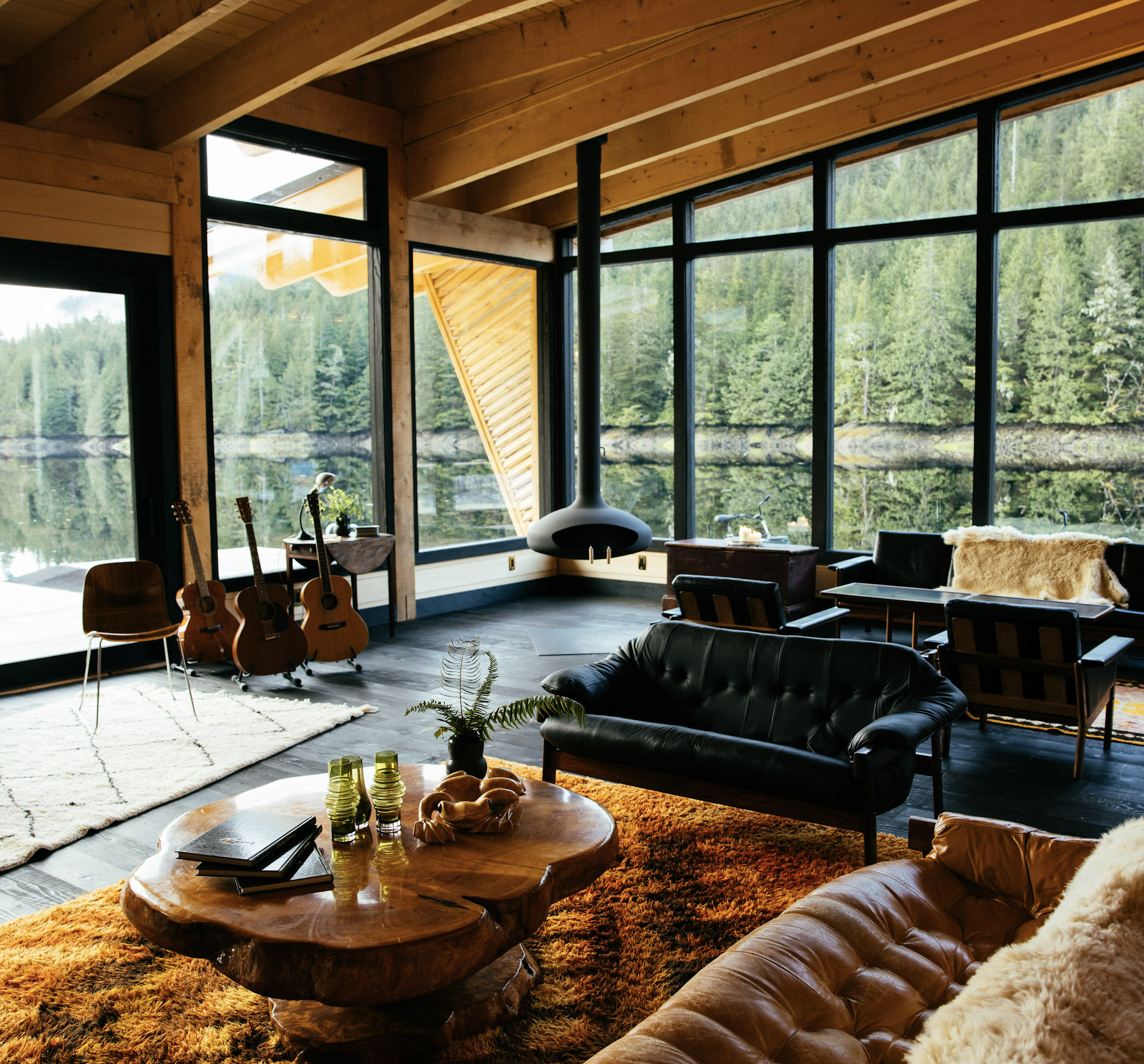 The Melody Lounge at Nimmo Bay, timber ceilings and floor-to-ceiling windows onto the forest and bay