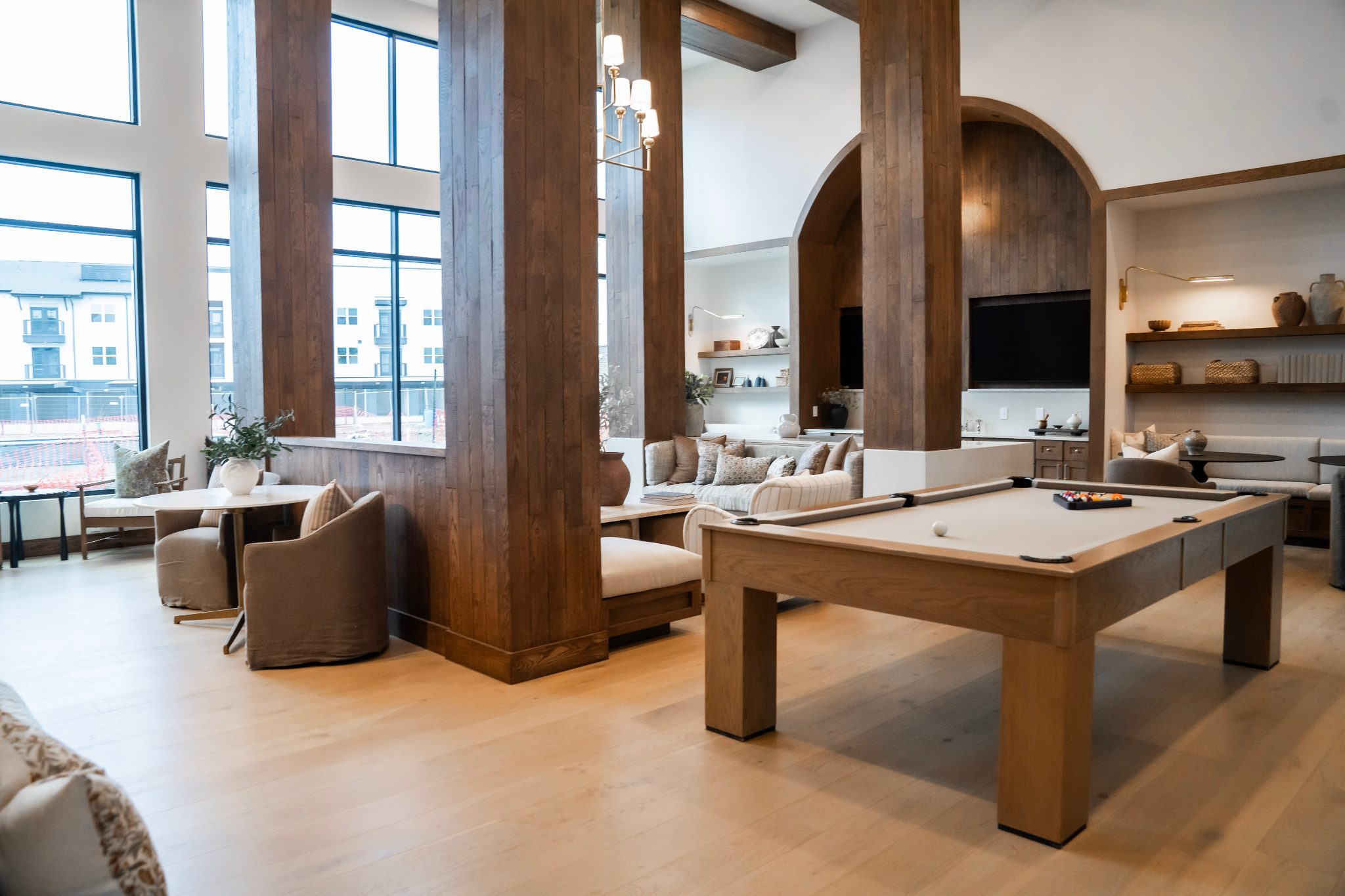 StoneHawk apartment community clubhouse lounge with wood columns and billiards table