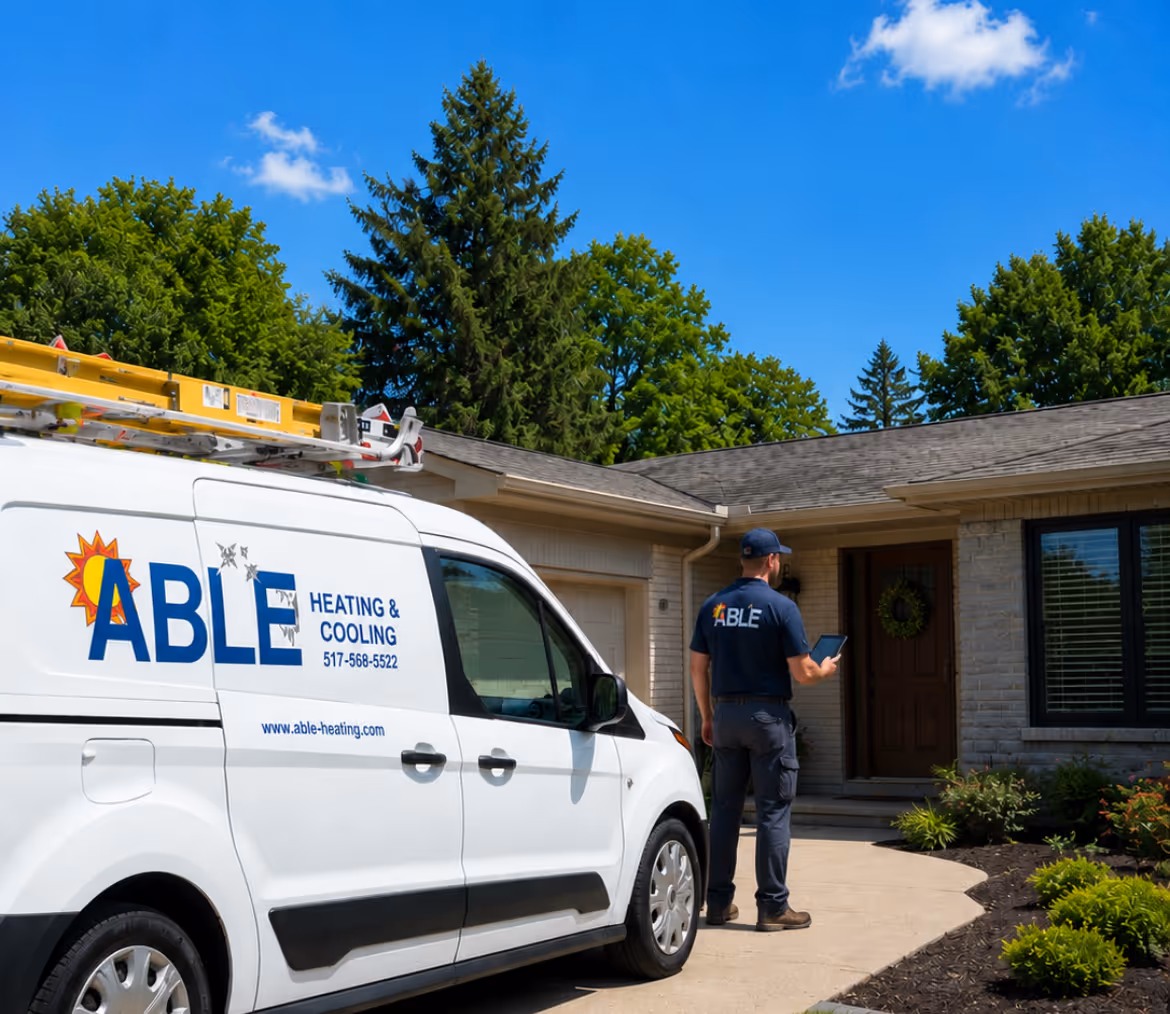 Able Heating & Cooling technician with tablet standing near company van outside a house on a sunny day.