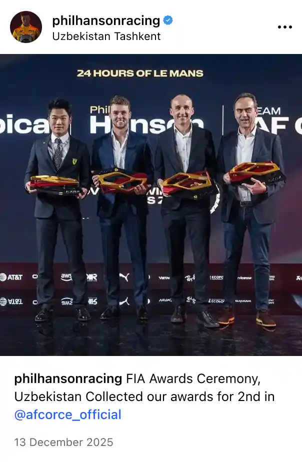 Four men in suits holding red and yellow racing car trophies at the 24 Hours of Le Mans FIA Awards Ceremony.