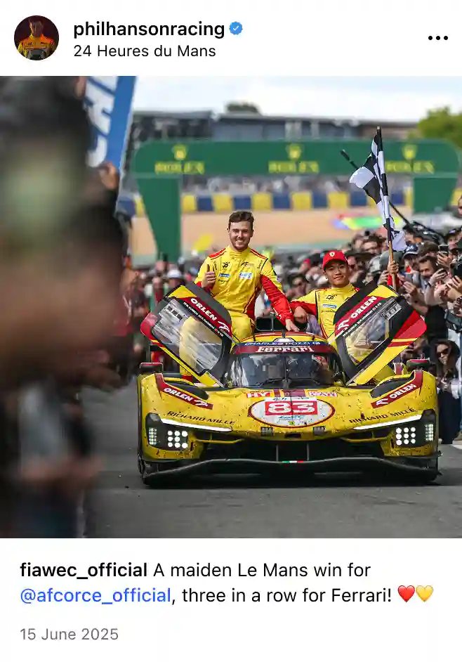 Two race car drivers in yellow suits celebrating on top of their yellow Ferrari race car with open doors and a checkered flag at the 24 Hours of Le Mans event.