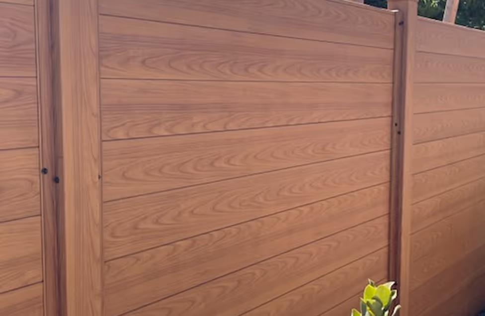Close-up of a modern wooden fence with horizontal slats and wood grain texture.