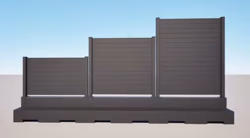 Three sections of a sleek aluminum privacy fence in varying heights against a clear blue sky.