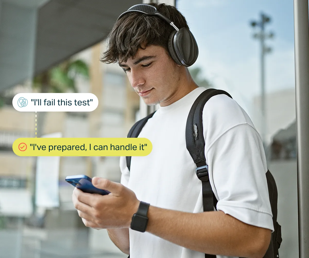 Young man with headphones and backpack looking at phone, with text bubbles showing self-talk: 'I'll fail this test' and 'I've prepared, I can handle it' emphasizing positive mindset.