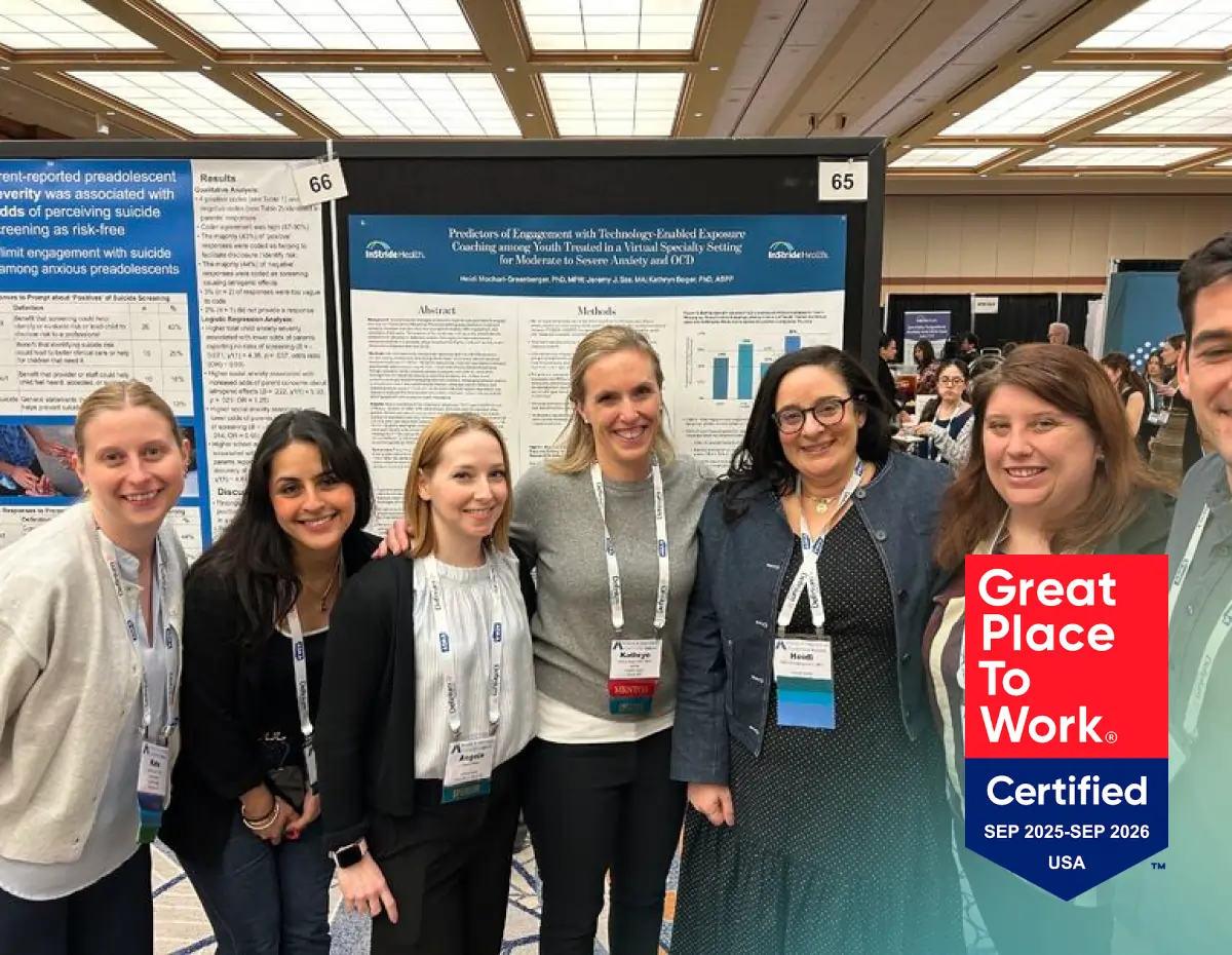 Group of six people standing and smiling in front of a scientific poster at a conference.