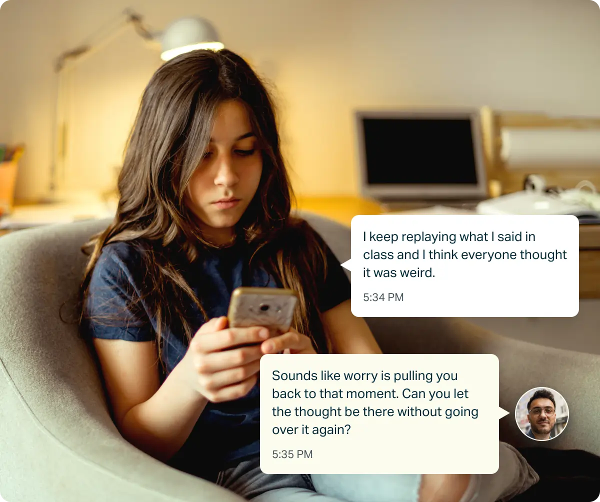Young woman sitting in a chair looking at her phone with text messages discussing resisting the urge to check due to OCD.