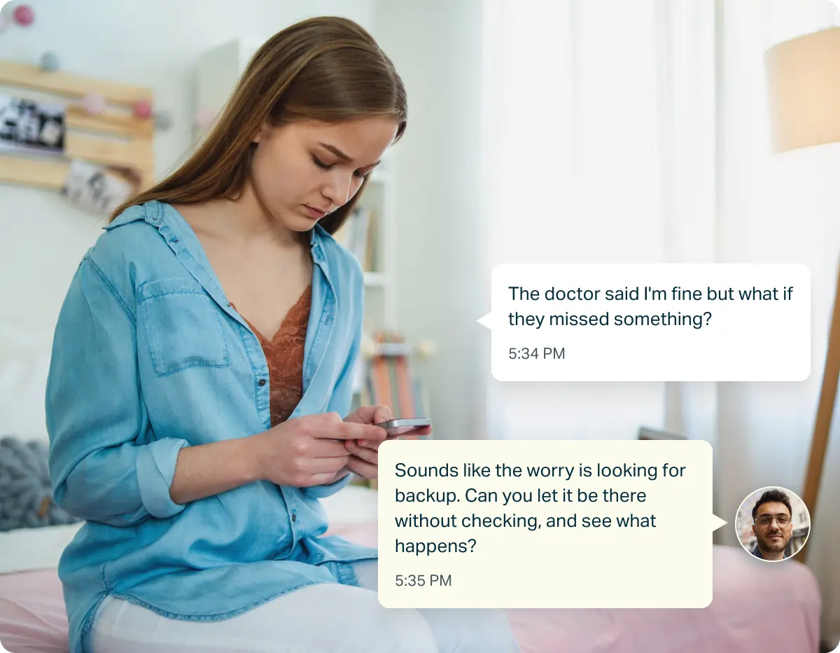 Young woman sitting in a chair looking at her phone with text messages discussing resisting the urge to check due to OCD.