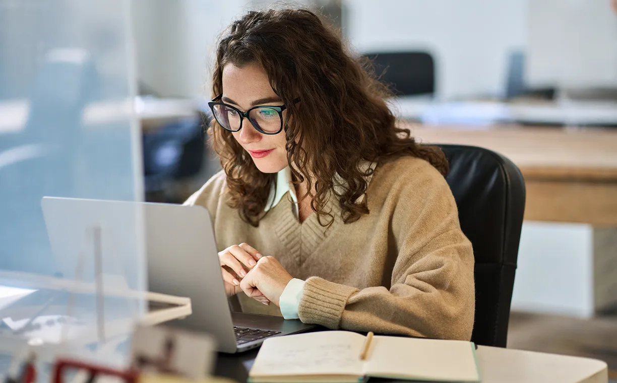 Smiling girl with glasses working