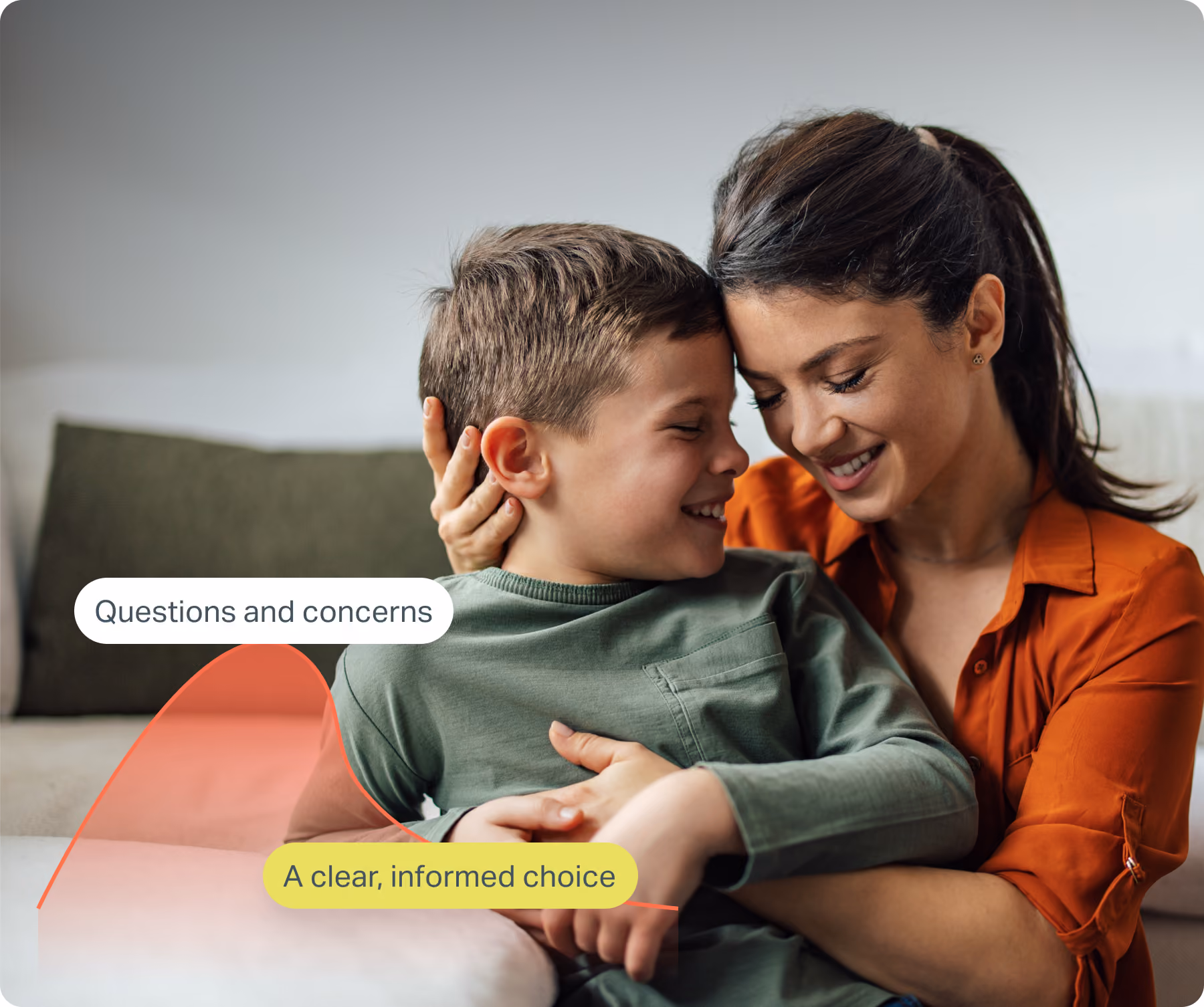 A smiling woman embraces a laughing young boy on a couch with their foreheads touching, with overlaid labels reading "Questions and concerns" and "A clear, informed choice."