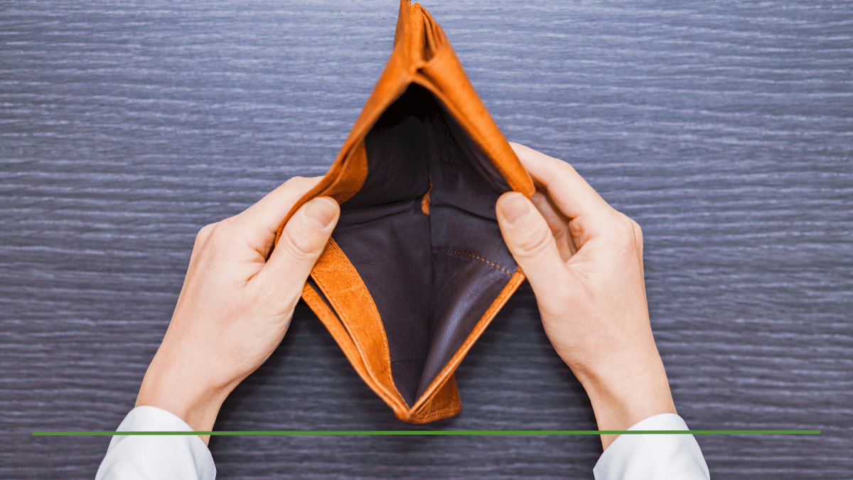 Empty leather wallet held open by two hands, symbolizing reduced income from claiming Social Security at age 62