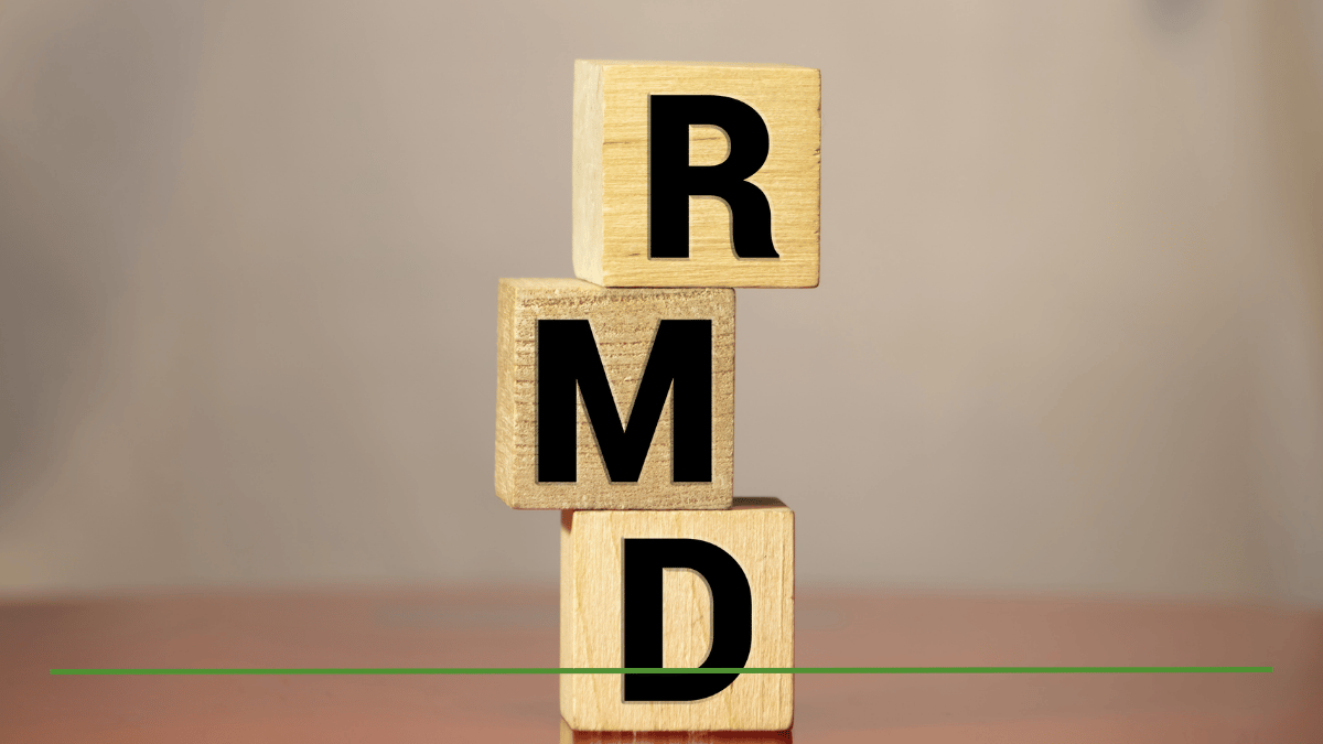 Wooden blocks spelling RMD, representing required minimum distribution rules and the biggest RMD mistake retirees make