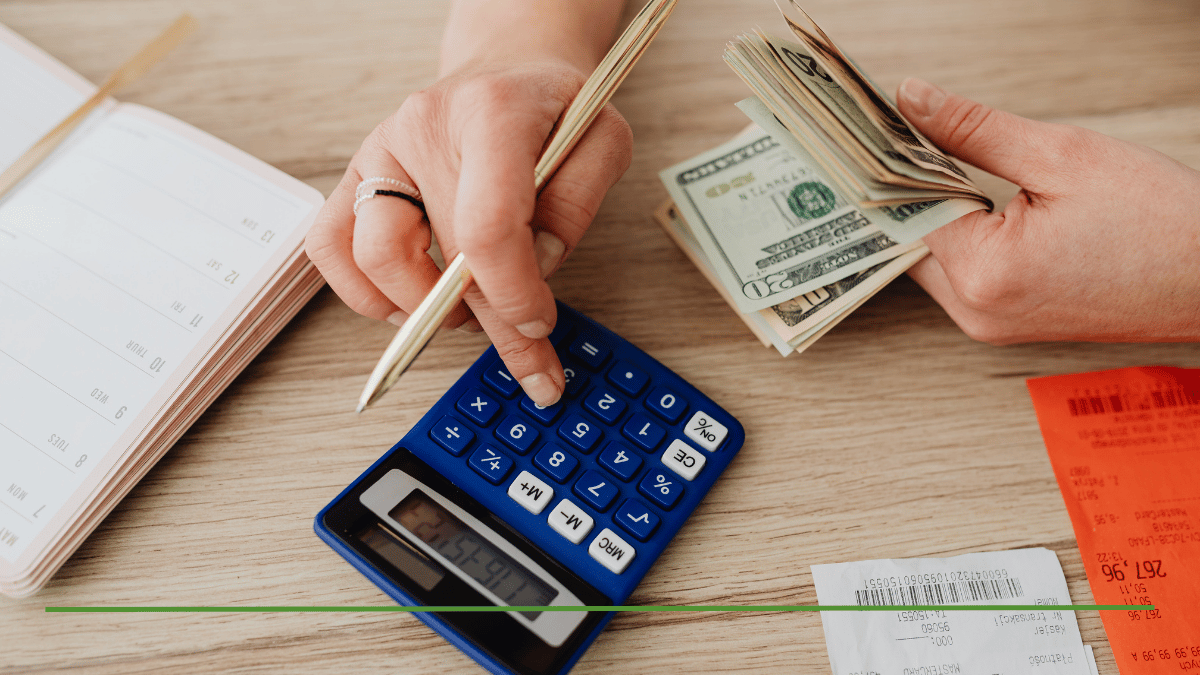 Financial advisor calculating RMD withdrawal strategy with calculator and cash