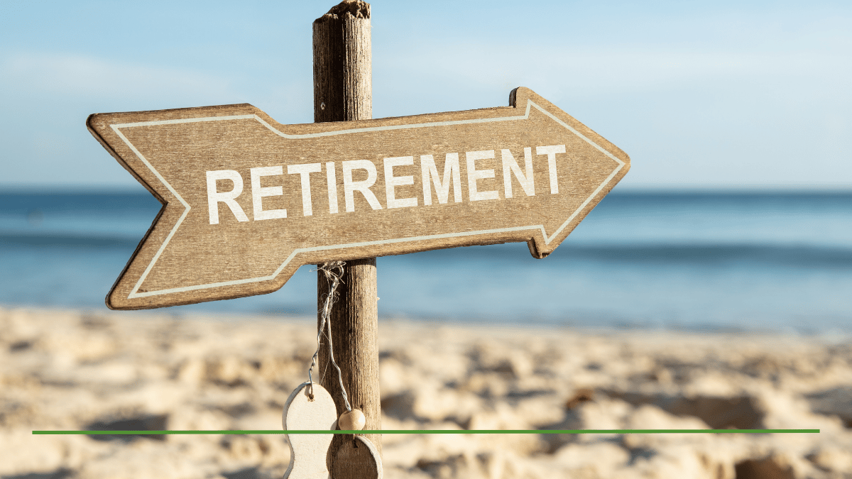 Wooden retirement sign pointing toward a beach, symbolizing the choice between a 401(k) and an IRA