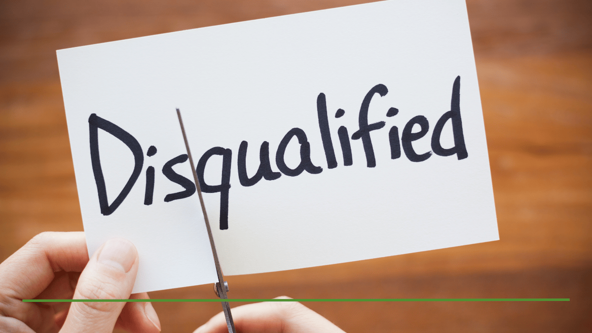 Hands cutting the word 'Disqualified' with scissors, representing overcoming Roth IRA income limits