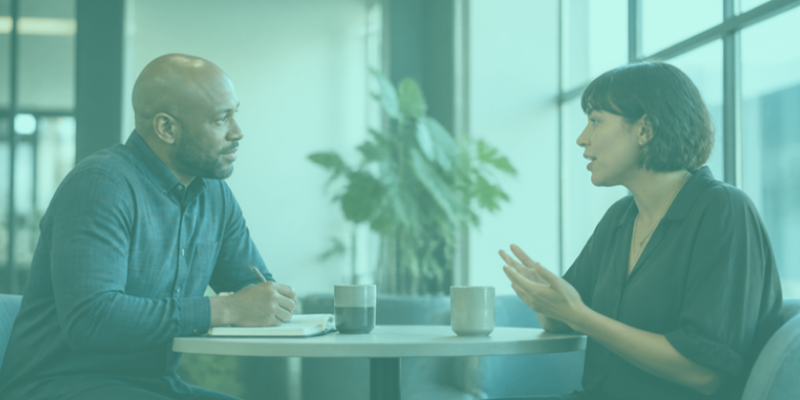 A manager listening closely as an employee talks during a one-on-one conversation