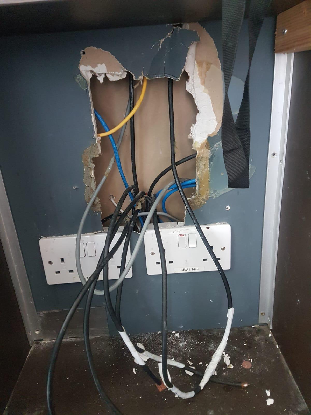 image of plumber working under a sink