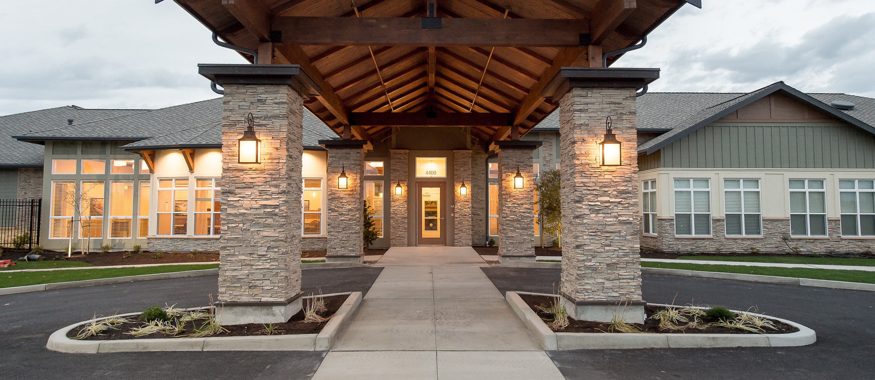 Silverado Memory Care covered stone entrance at dusk, Bellingham