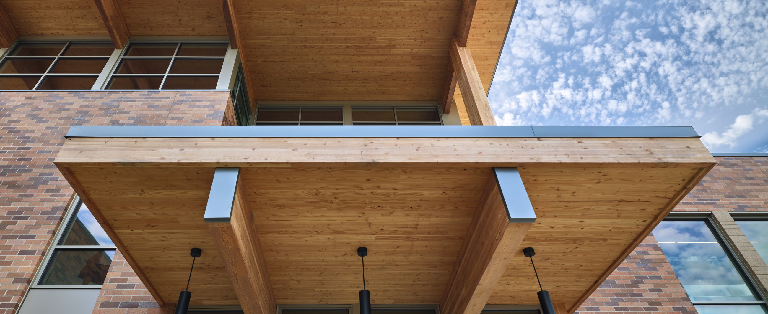 Exposed glulam timber canopy detail at the District Office Building entrance