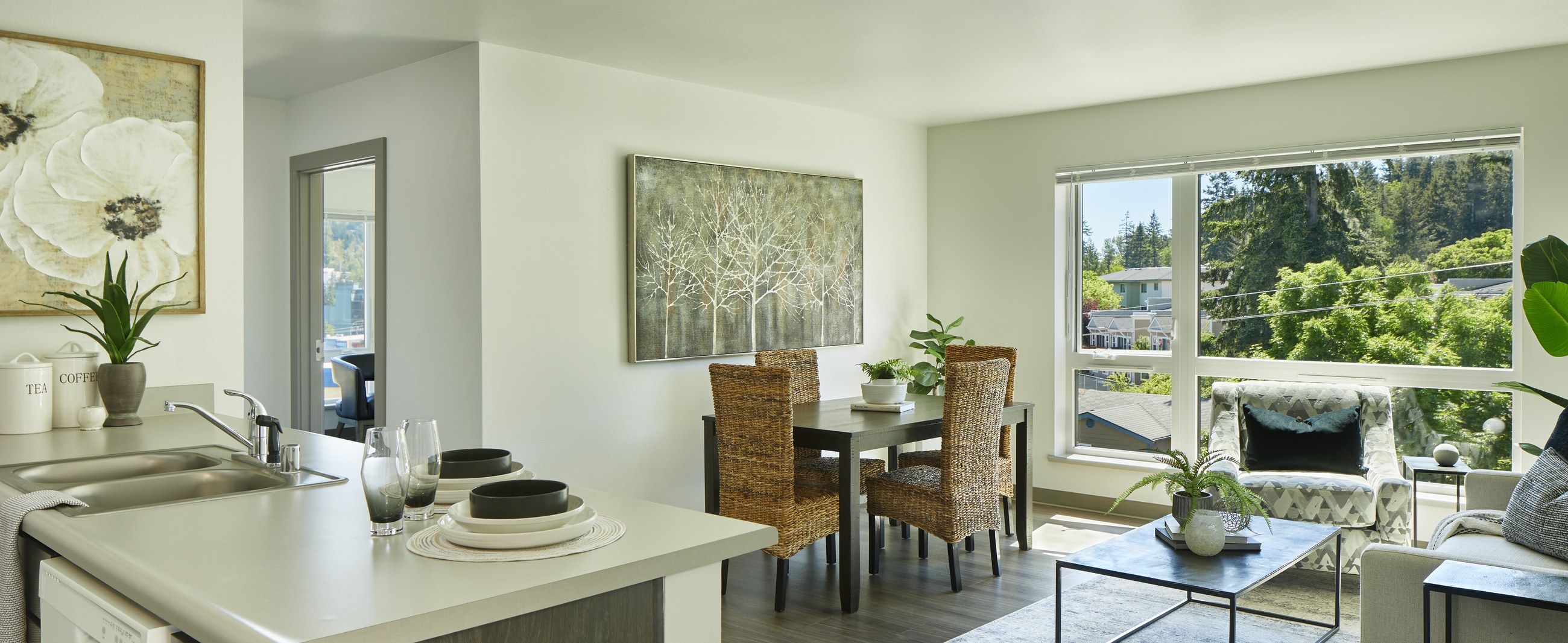 Staged kitchen and living area inside a Samish Commons apartment