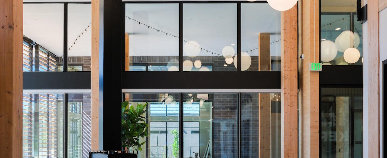 KERF Apartments interior atrium with glass and steel detailing