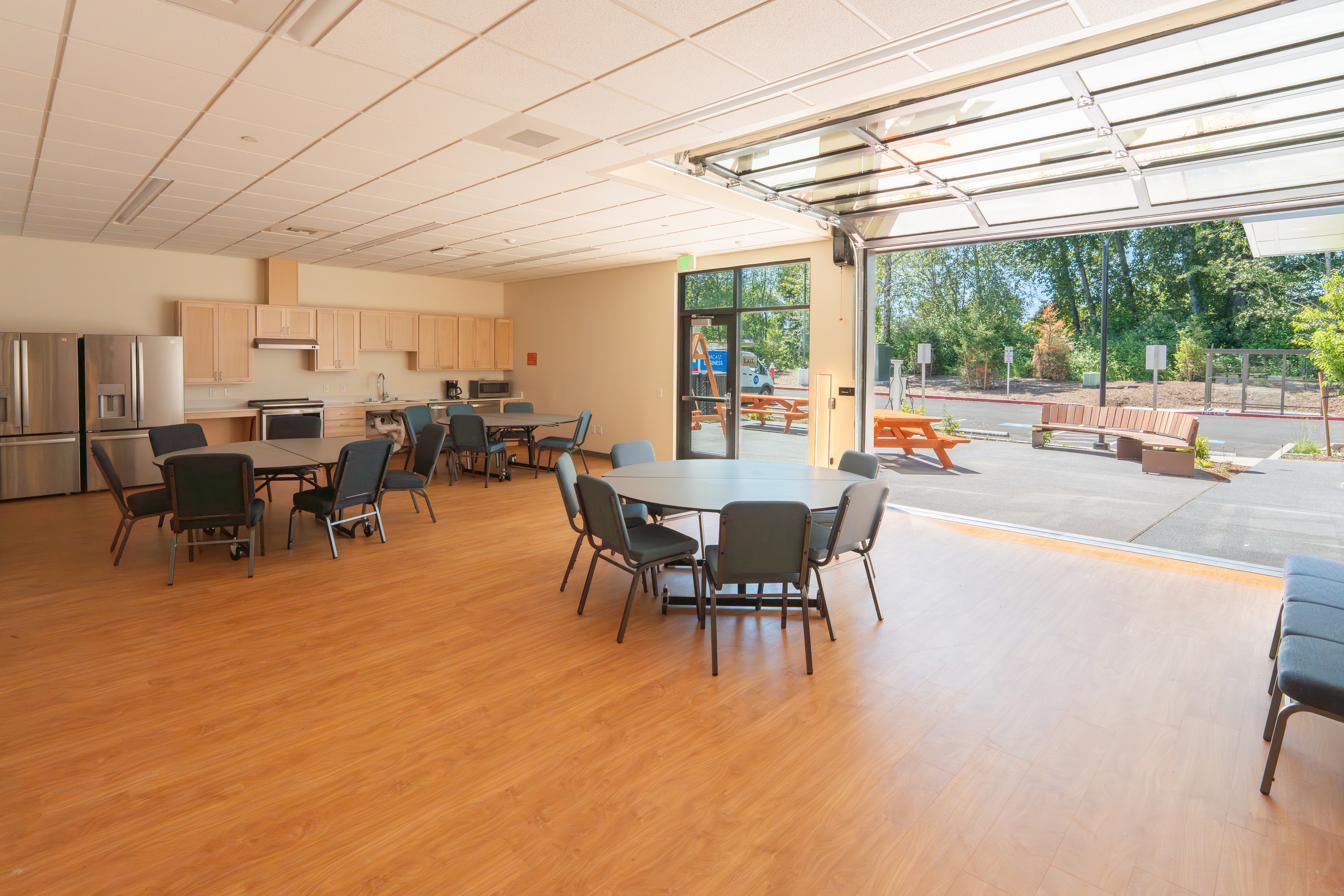 Community room opening to the outdoor patio at Bellis Fair Family Housing